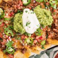Small Nachos · Tortilla chips layered with beans, cheese, tomatoes, sour cream and guacamole.