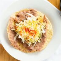 Tostada · Beans, lettuce, house taco sauce and Parmesan cheese.