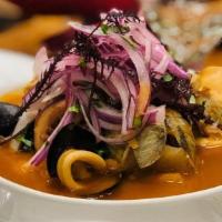 Parihuela De Mariscos · Peruvian mixed seafood soup, mothered with beer and a touch of aji panca.
