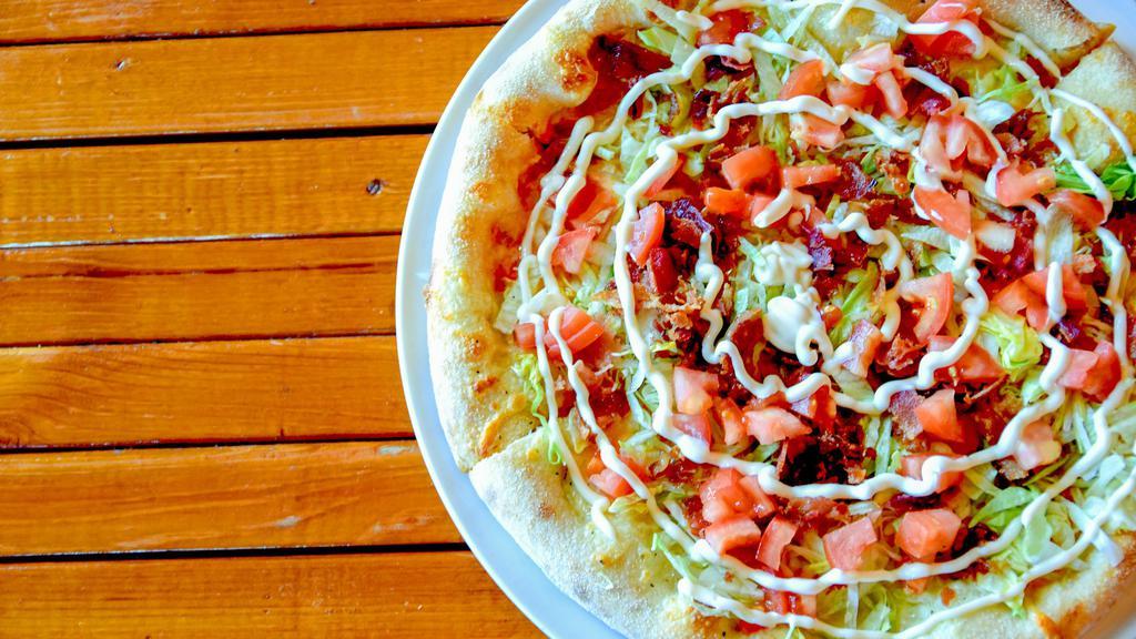 Blt Pizza · Roma tomatoes & thick sliced bacon, topped with lettuce and Hellman’s drizzle when out of the oven.