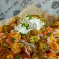 Tachos · Tater tots, beer cheese, cheddar, bacon, fresh jalapeños, green onions, pico & sour cream