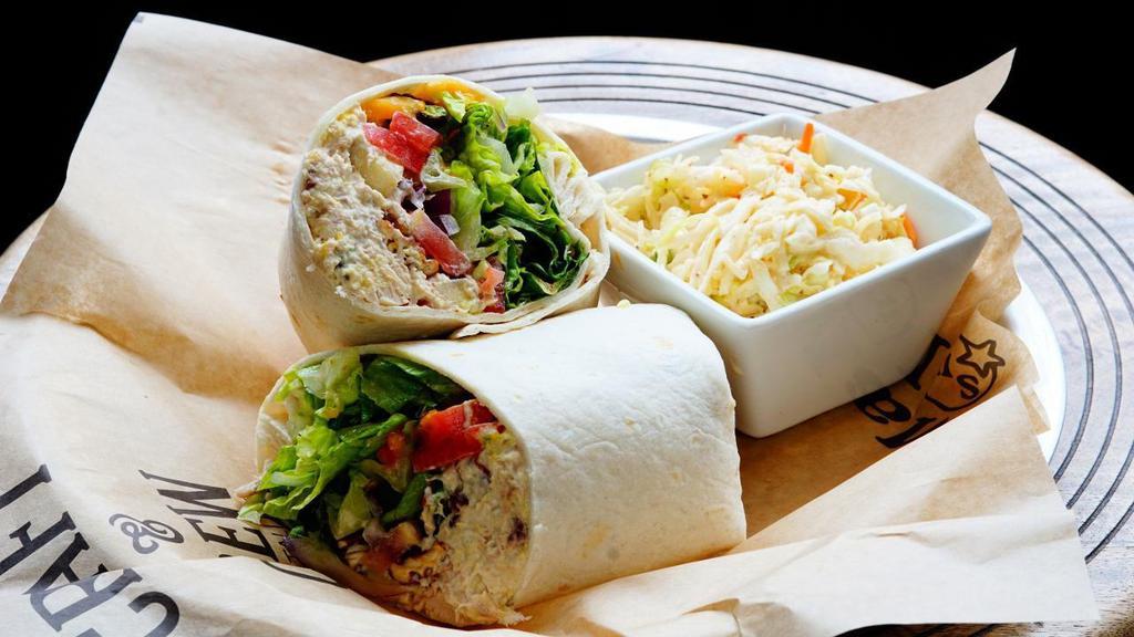 Chicken Salad Wrap · Chicken breast, mayonnaise, celery, grapes, craisins, honey roasted pecans, fresh mango, sliced tomato, romaine, wrapped in a flour tortilla