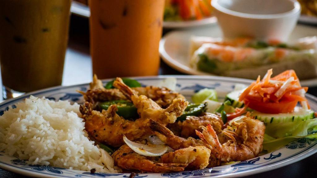 D2— Kim'S Special - Salted Peppered Prawns · Crispy fried prawns, stir-fried with onions and jalapeños. Served with steamed white rice, lettuce, cucumbers, tomatoes, pickled daikon and carrots.