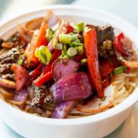 Tallarin Saltado · Spaghetti noodles cooked with onions, tomatoes, red peppers and soy based sauce.