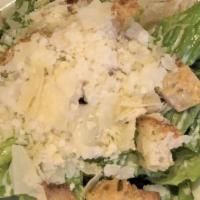 Caesar Salad · Romaine, Caesar dressing, herb croutons, and shaved Parmesan.