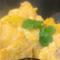 Tostones · Fried plantain with mojito dipping sauce.
