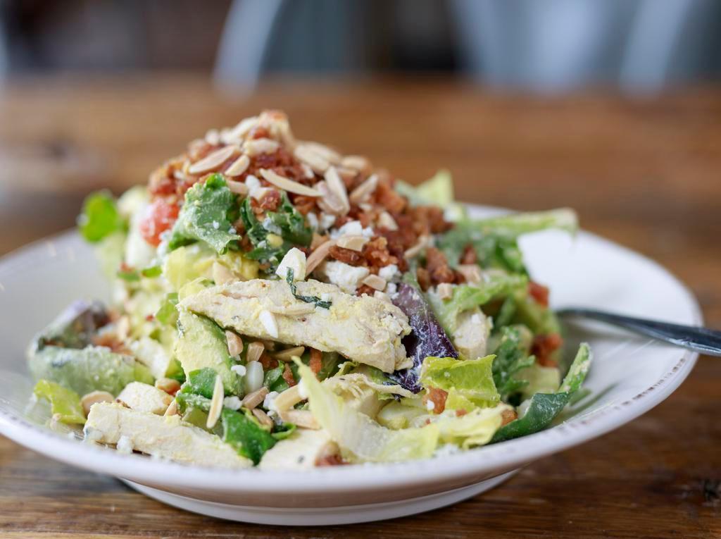 Chicken Cobb · organic romaine & mixed greens, roasted all-natural chicken, basil, sliced avocado, organic tomato, nitrite-free bacon, organic egg, blue cheese, almonds, topped with herb ranch dressing