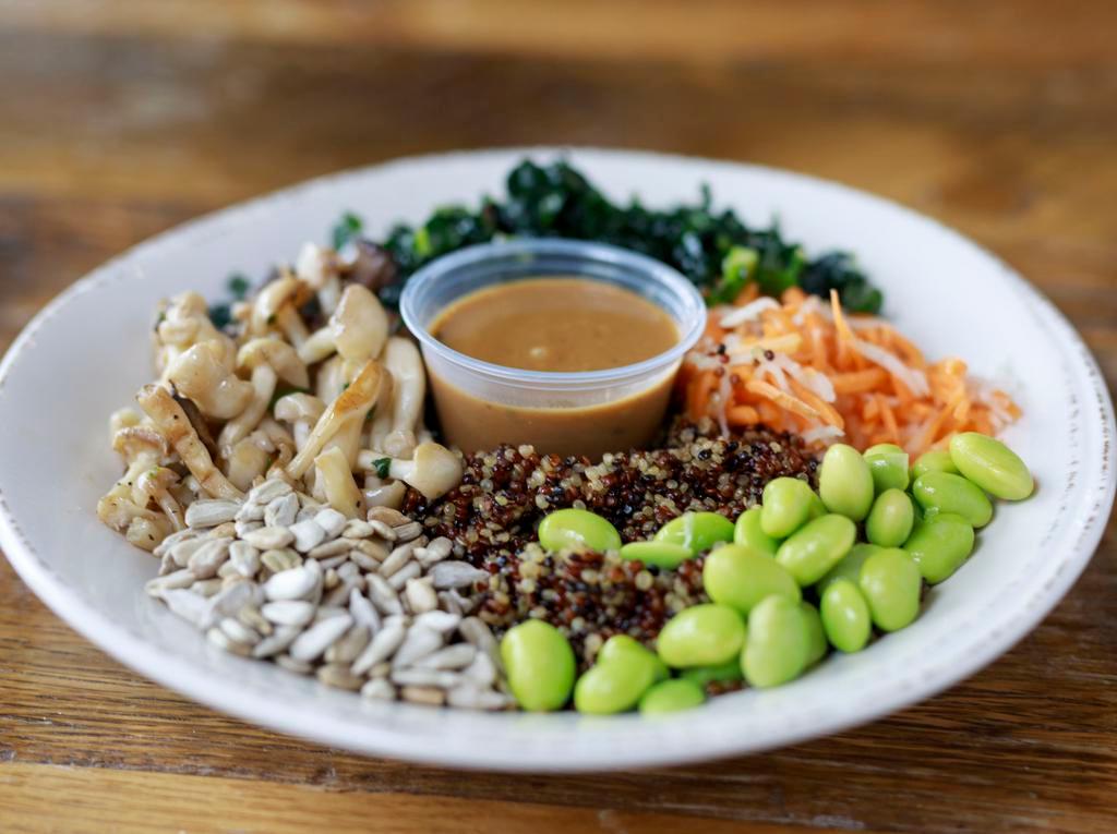 Skinny Buddha · organic raw kale salad, sliced avocado, truffled mushrooms, pickled daikon & carrots, edamame, quinoa, sunflower seeds, ginger miso sauce