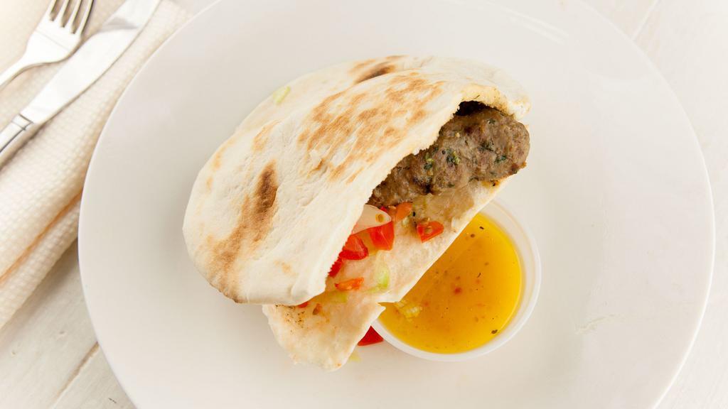Beef Kafta Sandwich · Char-broiled ground black Angus beef seasoned with chopped parsley, onions and spices in pita bread with lettuce, tomatoes and our special dressing.