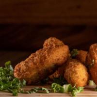 Jalapeño Poppers (6 Pcs.) · Six Jalapeño pepper halves stuffed with creamy cheddar cheese in a crunchy potato breading a...