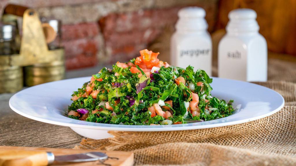Kale Quinoa Salad · A wholesome mix of fresh Kale, quinoa, diced tomato, and onion. Served with oil and lemon dressing