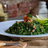 Tabbouleh Salad · A light and fresh mix of parsley, diced tomato, green onion and cracked wheat. Served with o...