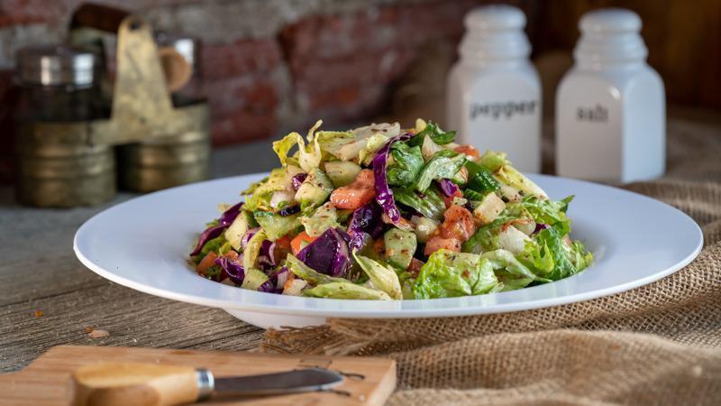 House Salad · A fresh mix of crisp romaine lettuce, tomato, cucumber, onion, shredded carrots and red cabbage. Served with our homemade House dressing