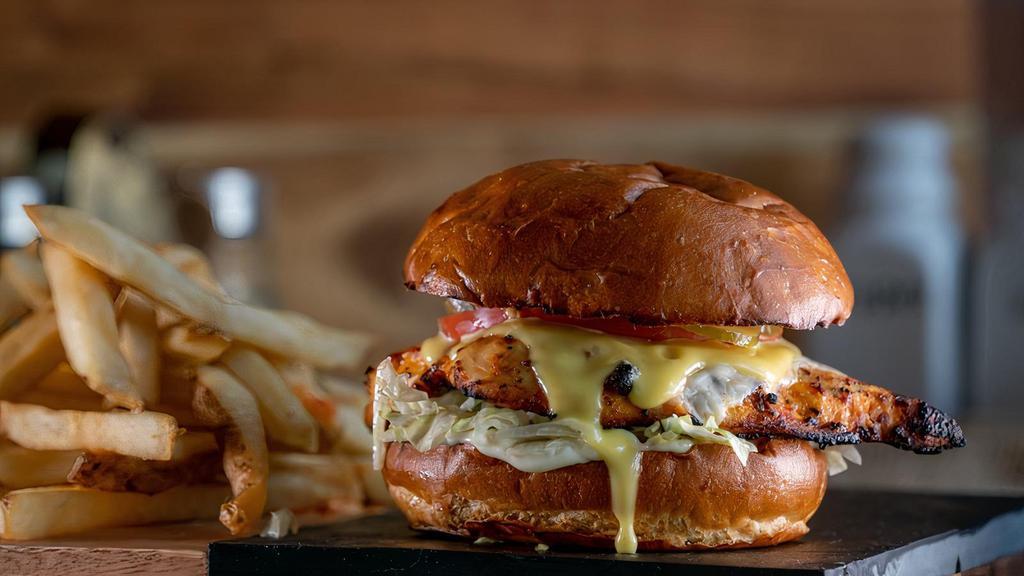 The Butcher'S Chicken Burger · Your choice of grilled chicken breast or fried chicken tenders layered with melted Swiss cheese, tomatoes, lettuce and pickles, and topped with creamy mayo and our homemade honey mustard sauce on a fresh plain bun