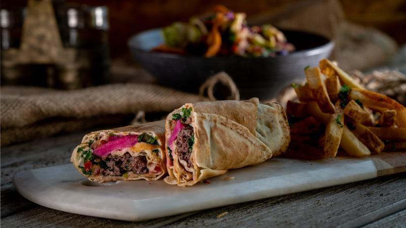 Beef Kafta Pita · Charcoal-grilled skewer of seasoned minced beef with onion and parsley, topped with Hummus, turnips and our special Sumac salad, served in a Pita bread