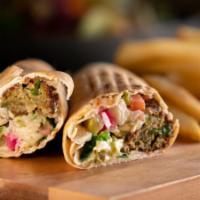 Falafel Pita · Fried crunchy Falafel, topped with pickles, tomato, parsley and Tahini Sauce, served in a Pi...