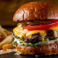 Junior Cheeseburger With Fries · A yummy flame-grilled black Angus beef patty topped with a slice of melted American cheese, ...