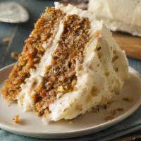 Carrot Cake Slice · Two thick layers, full of carrots, walnuts, pineapples and spices, frosted with a delicious ...