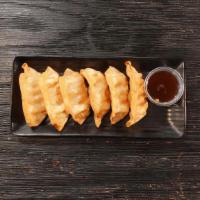 Crispy Pork Dumplings · Six Fried to perfection pork dumplings paired with our Ponzu Chili Sauce.