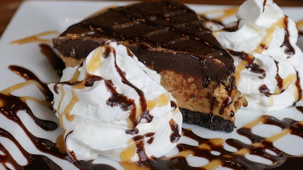 Buckeye Pie Slice · With chocolate drizzle & whipped cream.