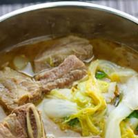 Galbi Tang · A hearty beef short-rib soup cooked with radishes, mushrooms, scallions, whisked egg and ver...