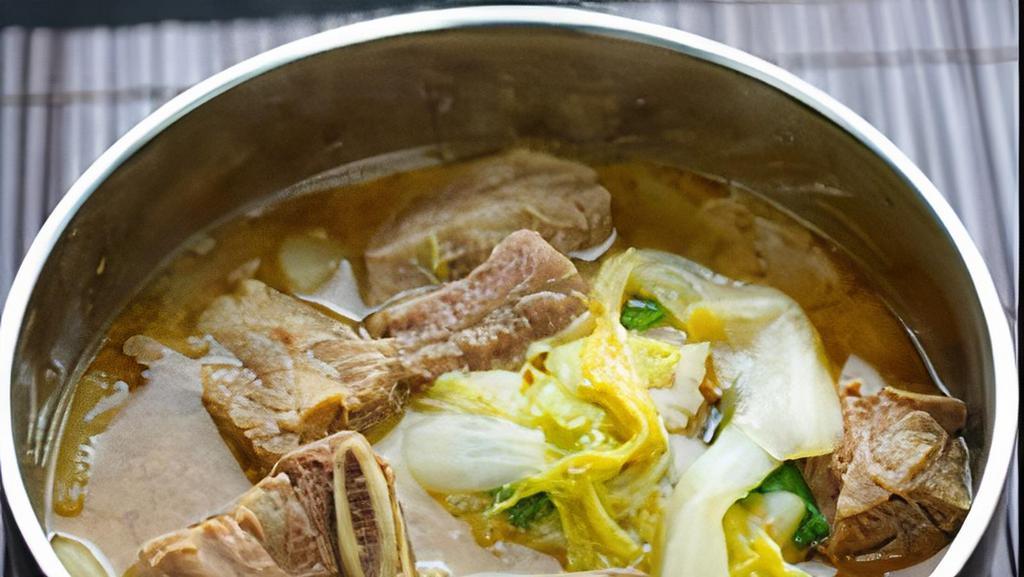 Galbi Tang · A hearty beef short-rib soup cooked with radishes, mushrooms, scallions, whisked egg and vermicelli noodles in a hearty garlic-beef broth.