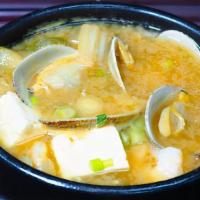 Haemul Doenjang Chigae · Shrimp, clam, tofu, scallions, zucchini, mushrooms, onions and jalapenos served boiling in a...