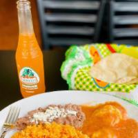 Huevos Rancheros · Two eggs covered in red salsa (not spicy but full of flavor) served with a side of rice and ...