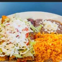Enchiladas De Queso · Four enchiladas filled with cheese served with rice and beans.