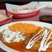 Chiles Rellenos · Vegetarian Option. Two poblano peppers filled with melted cheese coated in egg served with a...