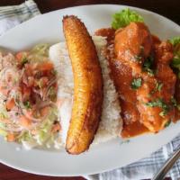 Seco De Pollo · Chicken stew served with rice, salad, sweet plantain, and cilantro.