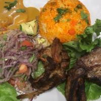Chuleta A La Parrilla · Grilled pork chop, served with rice, beans, salad, and sweet plantain.