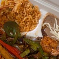 Fiesta Fajitas · Marinated Strips of Juicy Steak, Tender Chicken Breast and Tasty Shrimp Sauteed with Green a...