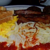 Mom'S Deluxe · Two eggs any style, two ham strips, two bacon strips, two sausage patties and hash browns.

...