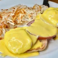 Classic Eggs Benedict · Canadian bacon, two poached eggs on an English muffin, topped with hollandaise sauce.