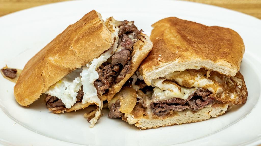 Pan Con Bistec A Caballo · Steak, grilled onions, cheese, string potatoes, fried egg.
