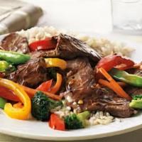 Steak  Stair Fry · served with veggies on a bed of rice with sauce and bread