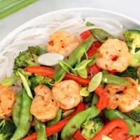 Shrimp  Stair Fry · served with veggies on a bed of rice with sauce and bread.