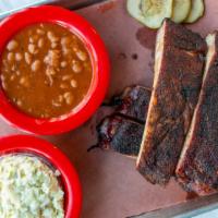 Rib Plate · Dry rubbed, hickory smoked St. Louis ribs and your choice of two sides.