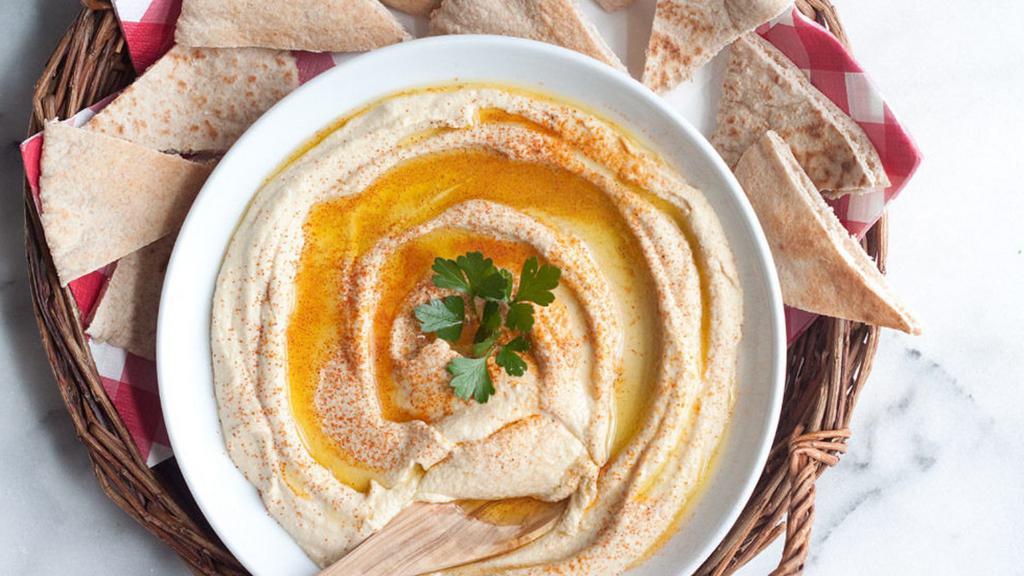 Hummus · Mashed chickpeas blended with tahini, olive oil, lemon juice served with pita bread.