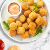 Thoughts For Tots · (Vegetarian) Shredded Idaho potatoes formed into tots, battered, and fried until golden brown.