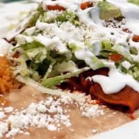 Enchiladas · Chicken, red sauce enchiladas served with lettuce, tomato, avocado, Mexican cheese, and sour...