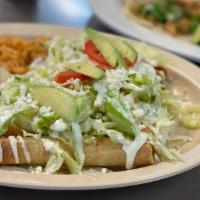 Flautas · Six corn tortillas filled with shredded chicken, then deep fried. Our flautas are topped wit...