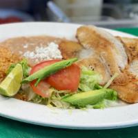 Filete De Pescado · Tilapia two delicious fillet of fish grilled to perfection with butter. Served with rice, be...