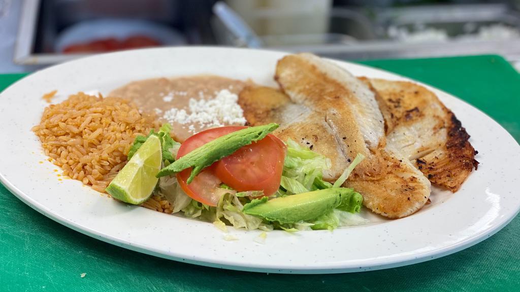 Filete De Pescado · Tilapia two delicious fillet of fish grilled to perfection with butter. Served with rice, beans, small side salad, and four hand made tortillas.