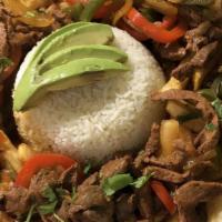 Lomito Saltado · Sauteed jumbo top round steak in an onion sauce. Served with rice, avocado, and tossed in fr...