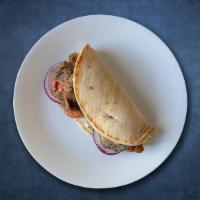 Gyro  Sub Genghis · Gyro meat, cucumber sauce, onions, lettuce, and tomatoes on pita bread.