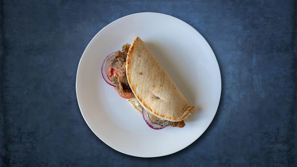 Gyro  Sub Genghis · Gyro meat, cucumber sauce, onions, lettuce, and tomatoes on pita bread.