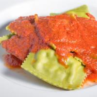 Ravioli Alla Reggiana · Choice of creamy cheese filled spinach ravioli or beef ravioli served with tomato, cream or ...