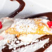 Cannoli · A delicate, crispy pastry filled with sweetened orange whipped ricotta and sprinkled with po...